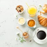Continental breakfast on stone table from above - flat lay